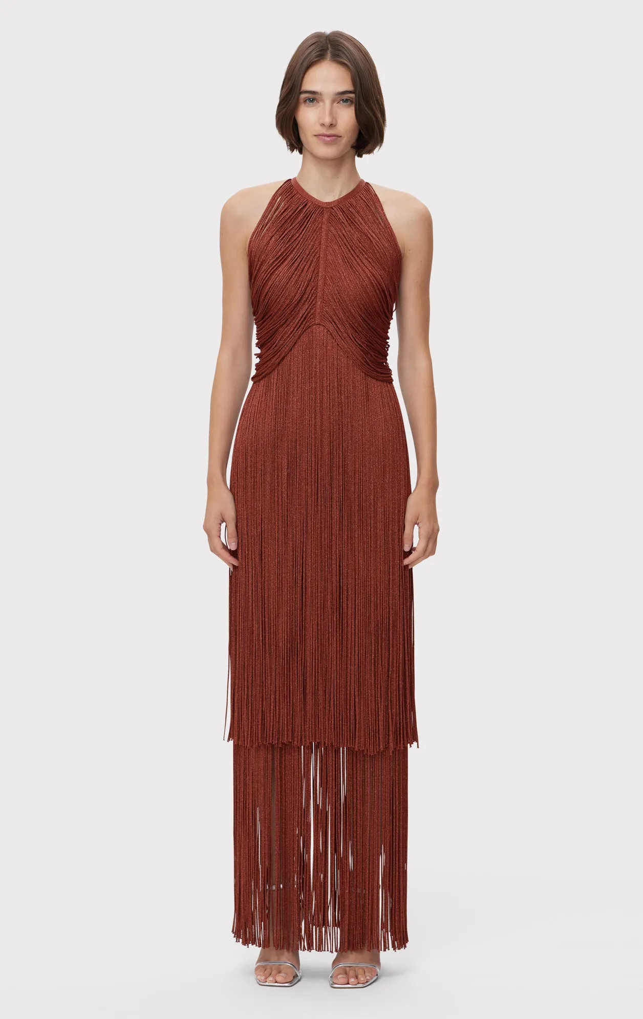 METALLIC DRAPED FRINGE HALTER GOWN sold by Herve Leger