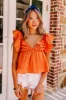 Stay Here Awhile Peplum Top In Rust sold by Impressions