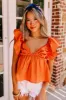 Stay Here Awhile Peplum Top In Rust sold by Impressions