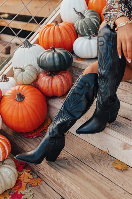 The Jessica Faux Leather Knee High Cowboy Boot in Black sold by Impressions