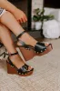 The Trisha Faux Leather Wedge in Black sold by Impressions