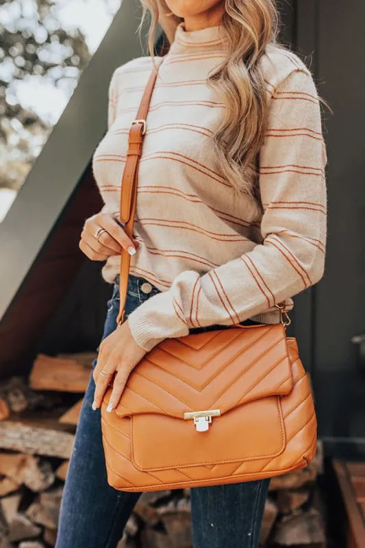 Locking Eyes Quilted Faux Leather Purse In Pumpkin sold by Impressions