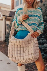 Travel Far Puffer Tote In Beige sold by Impressions
