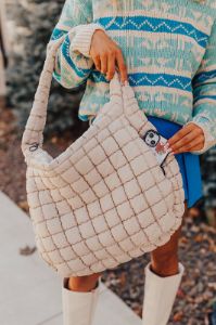 Travel Far Puffer Tote In Beige sold by Impressions