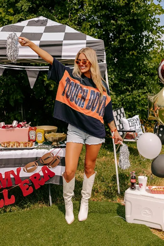 It's a Touch Down Sequin Oversized Tee in Navy/Orange sold by Impressions