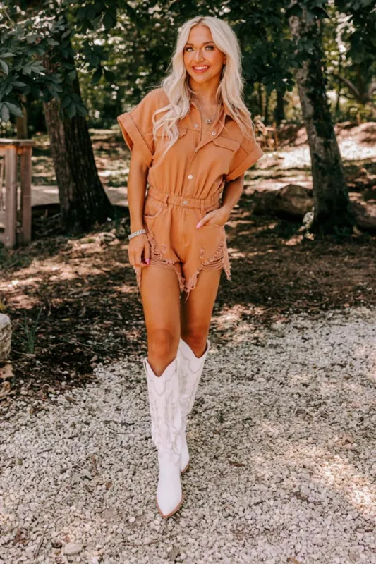 The Juni Distressed Denim Romper In Camel sold by Impressions