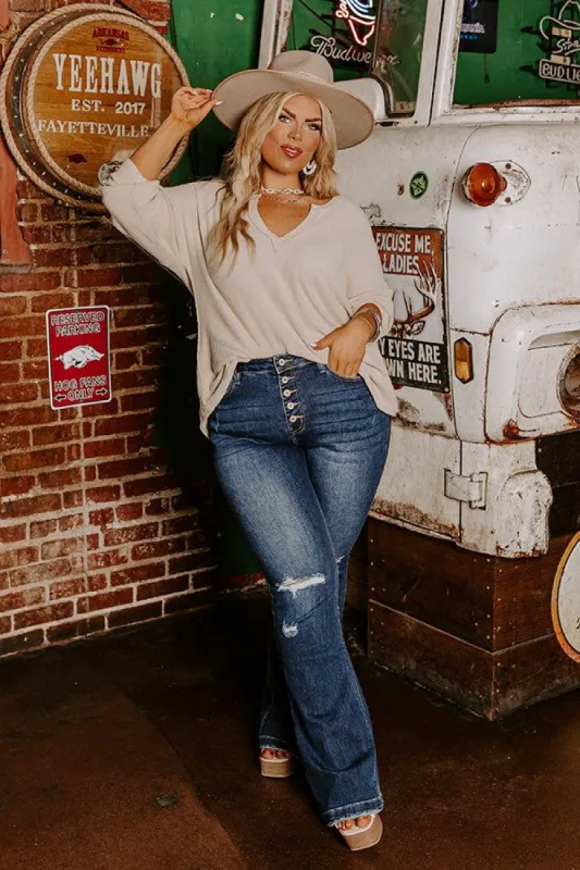 The Nikky Midrise Distressed Flare in Dark Wash Curves sold by Impressions