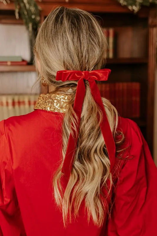 The Alice Long Velvet Bow Hair Clip in Red sold by Impressions