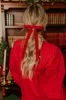 The Alice Long Velvet Bow Hair Clip in Red sold by Impressions