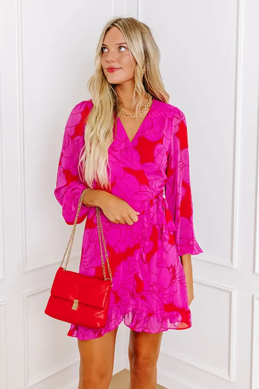 Dinner and a Movie Floral Wrap Dress in Fuchsia sold by Impressions