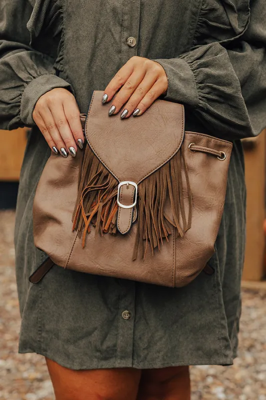 The Kenzo Faux Leather Fringe Backpack In Taupe sold by Impressions
