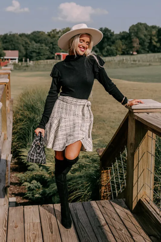 Fashionably Late Ruffle Top in Black sold by Impressions