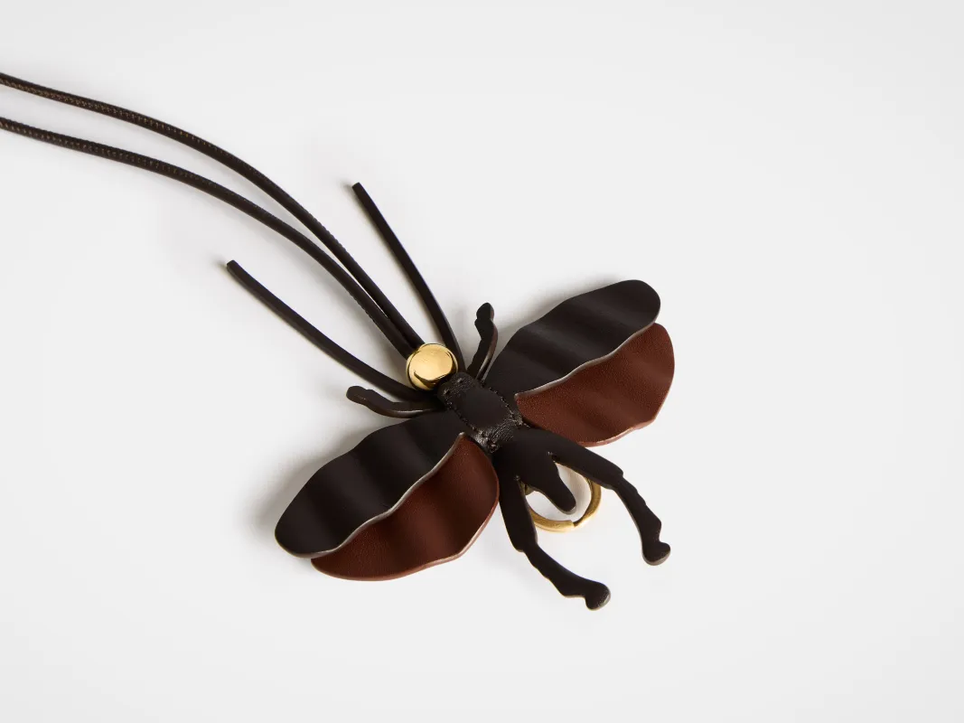 MOTH CHARM IN CHOCOLATE BROWN sold by J.W. Anderson