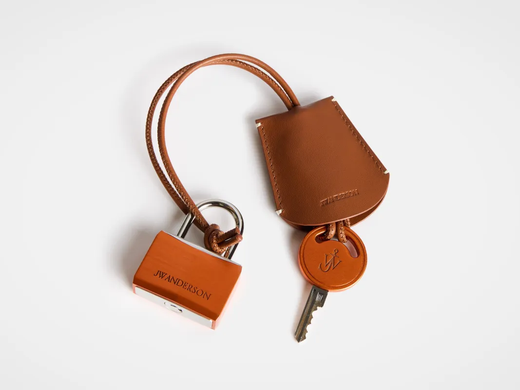 PADLOCK CHARM IN ORANGE sold by J.W. Anderson