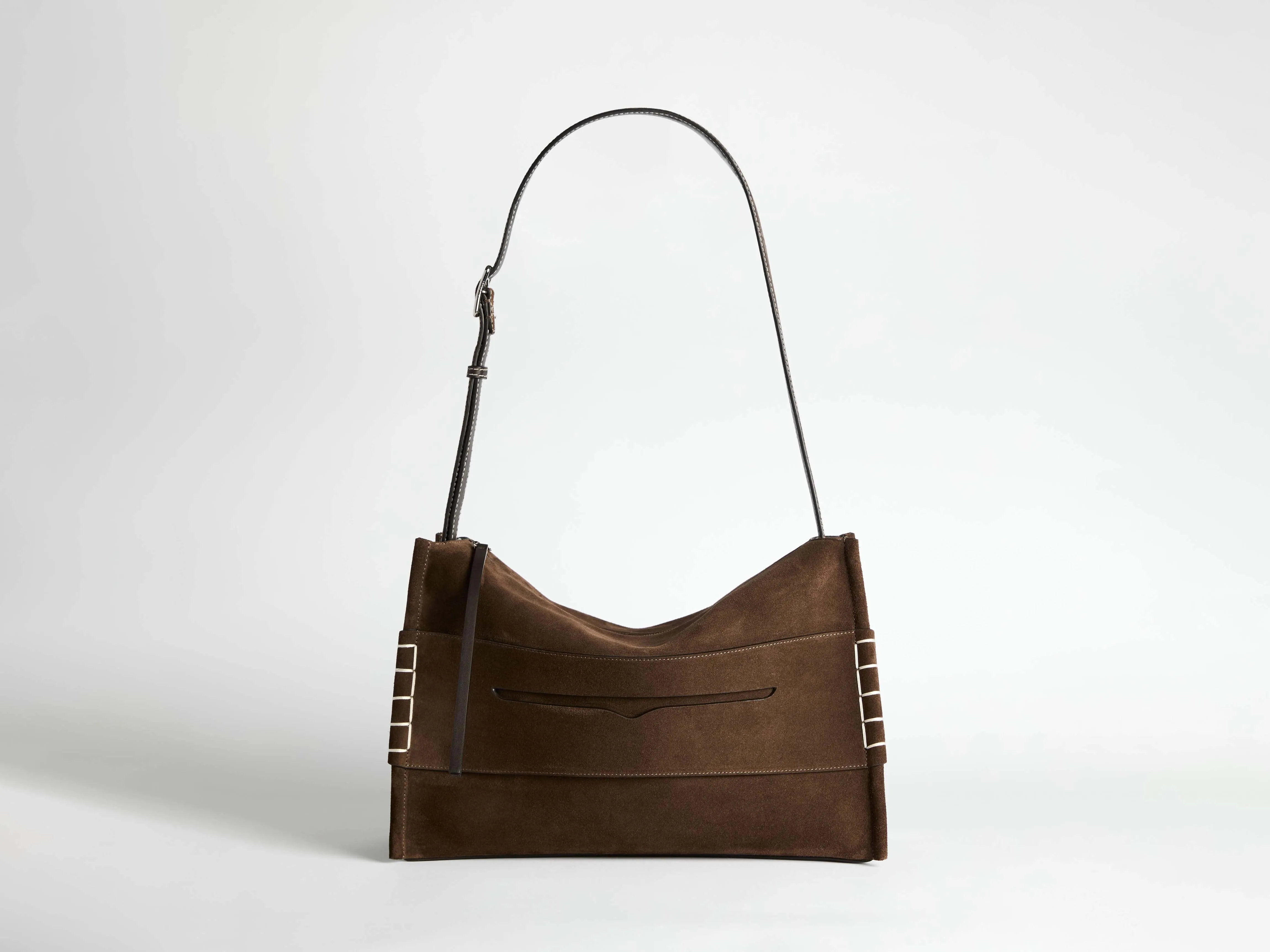 MESSENGER LOAFER BAG IN CHOCOLATE BROWN SUEDE sold by J.W. Anderson