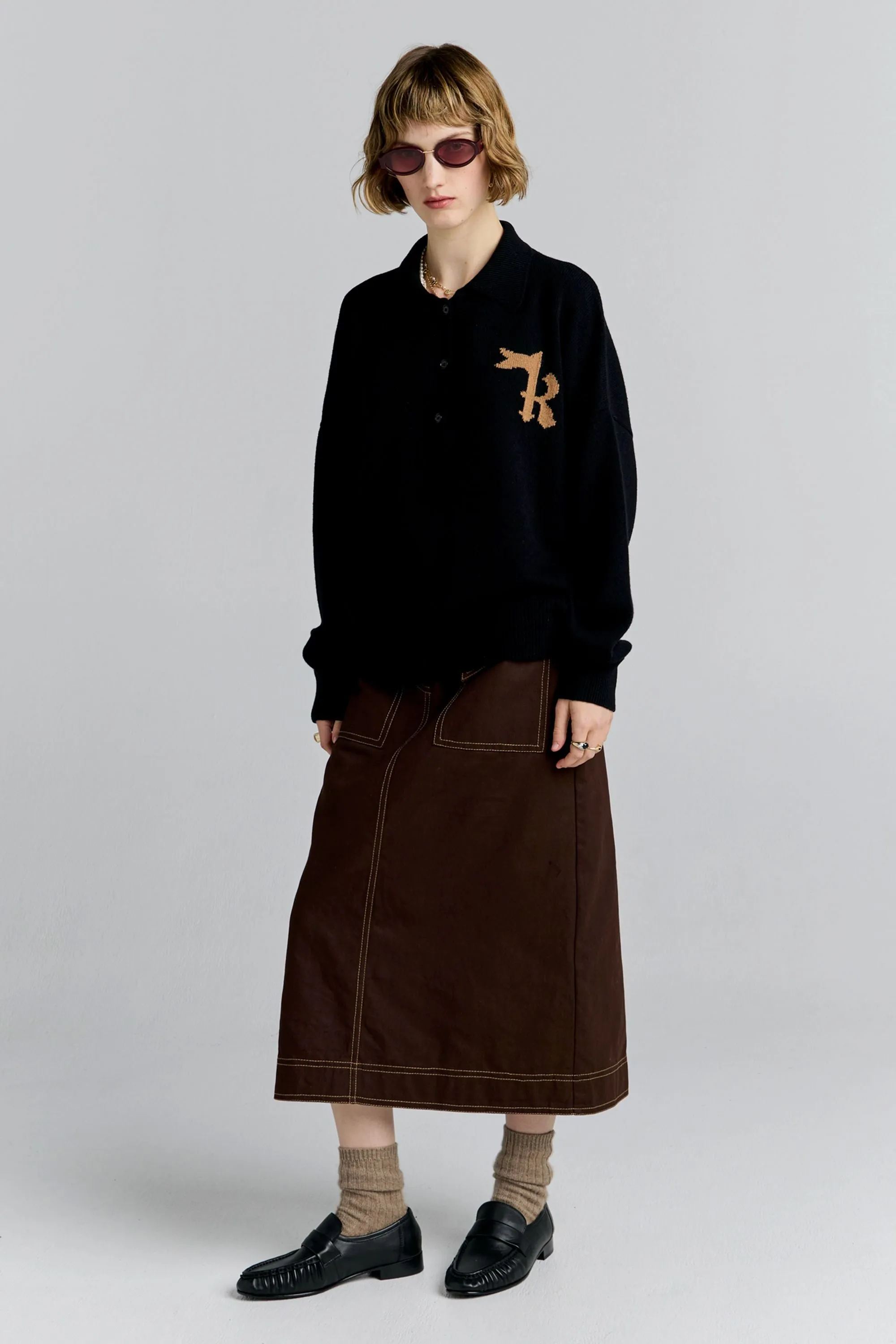 K Flag Polo Black sold by Karen Walker