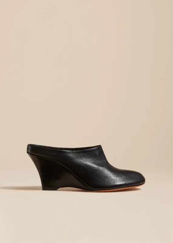 The Apollo Wedge Mule in Black Leather sold by KHAITE