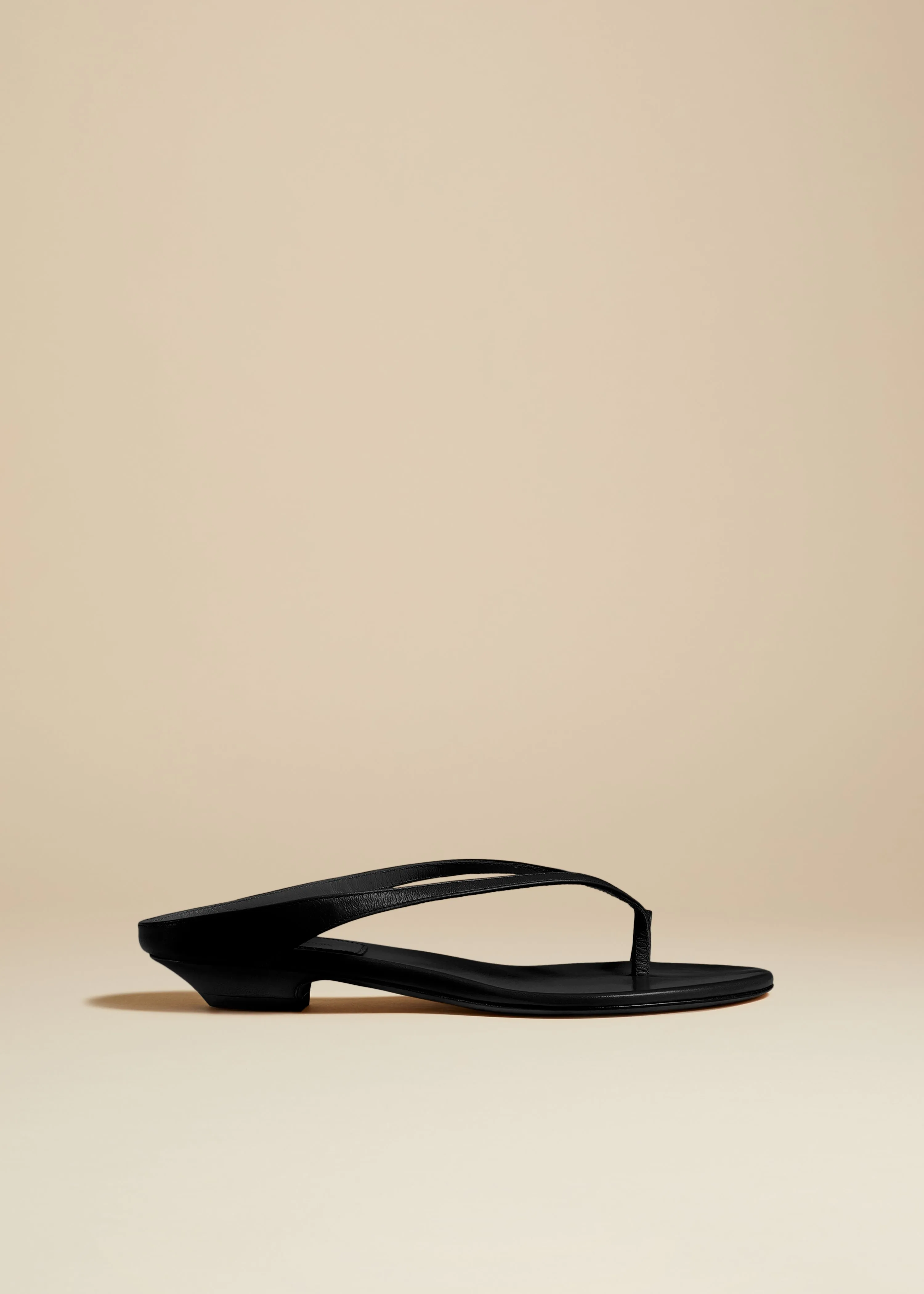 Marion Thong Sandal in Black Leather sold by KHAITE