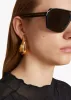 Medium Olivia Hoop Earrings in Gold sold by KHAITE