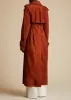 The Rennie Trench in Rust Suede sold by KHAITE