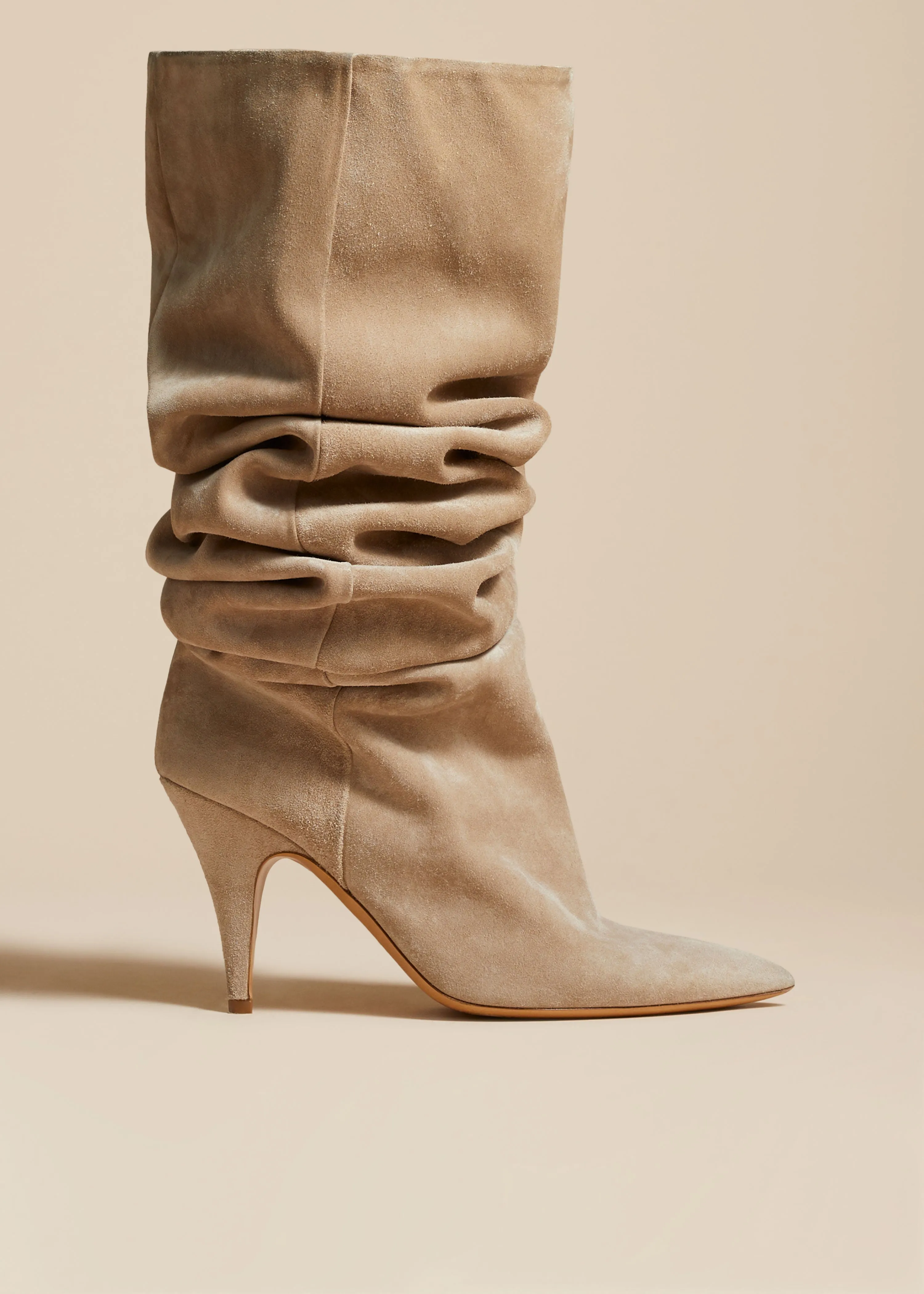 The River Knee-High Boot in Beige Suede sold by KHAITE
