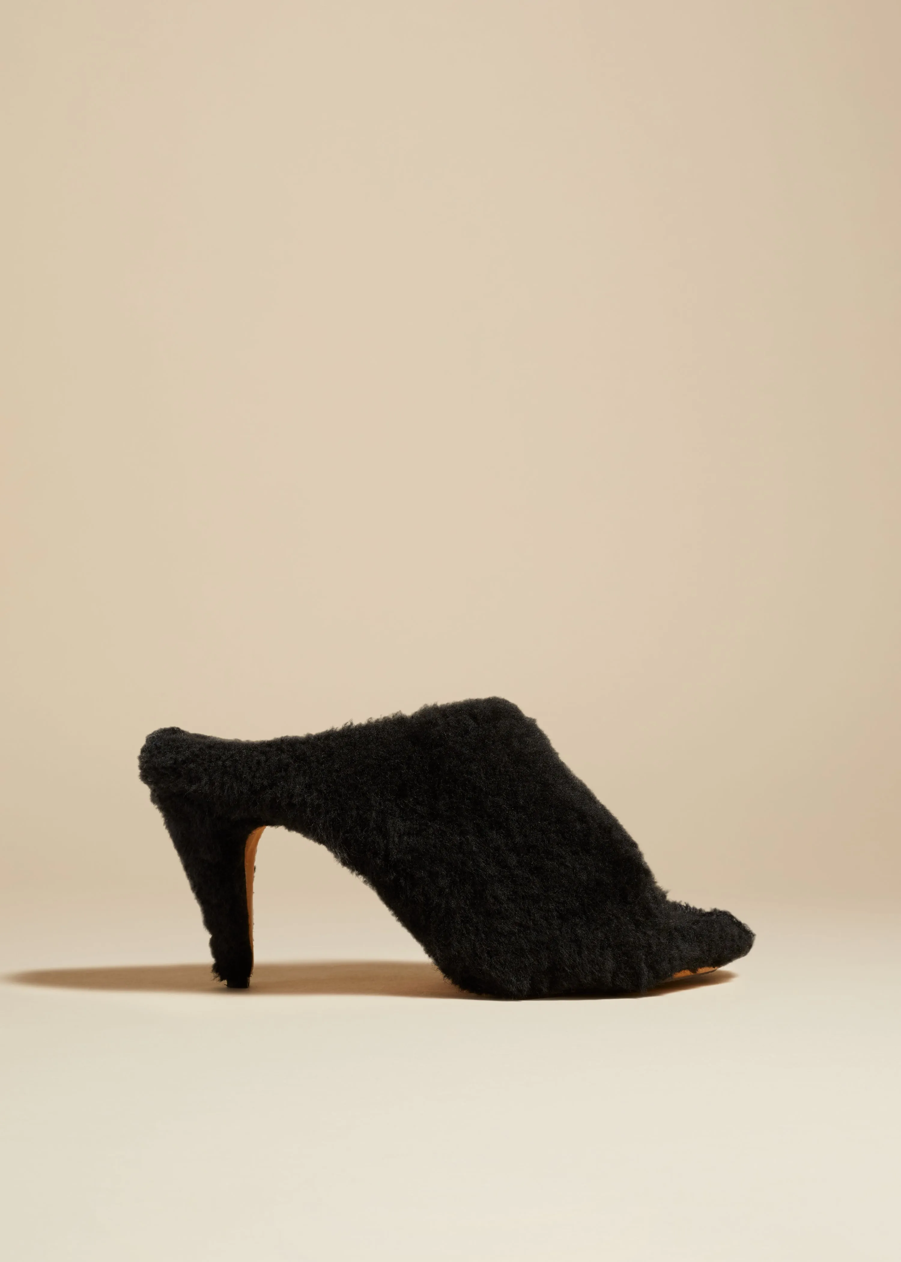 The Marion Mule Sandal in Black Shearling sold by KHAITE