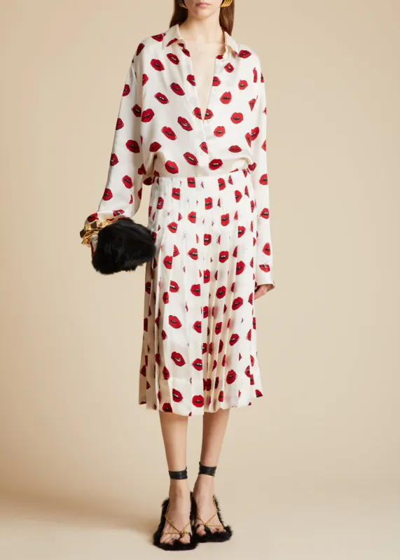 The Tudi Skirt in Cream with Red Lip Print sold by KHAITE