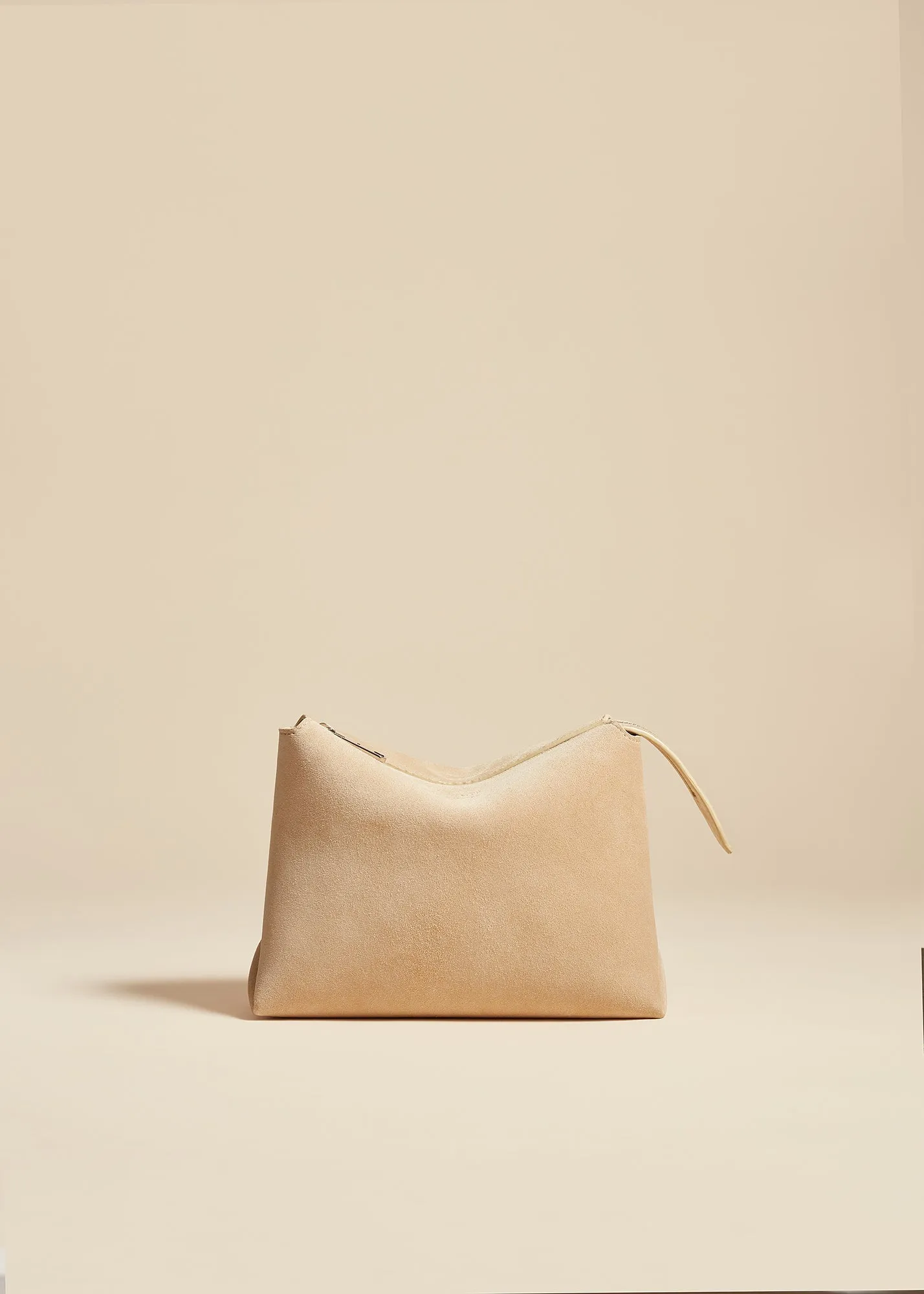 Lina Pochette in Dark Ivory Suede sold by KHAITE
