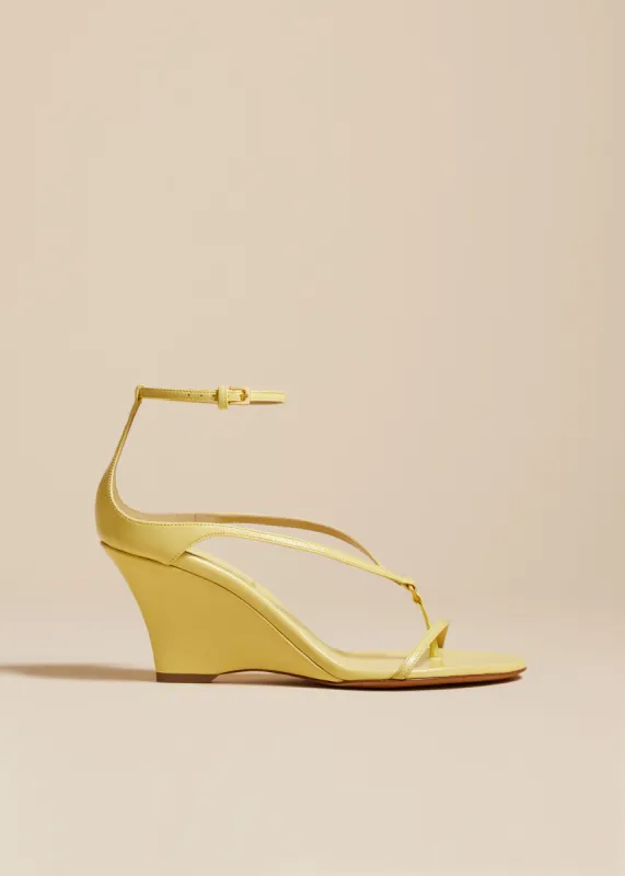 The Marion Strappy Wedge Sandal in Pale Yellow Leather sold by KHAITE