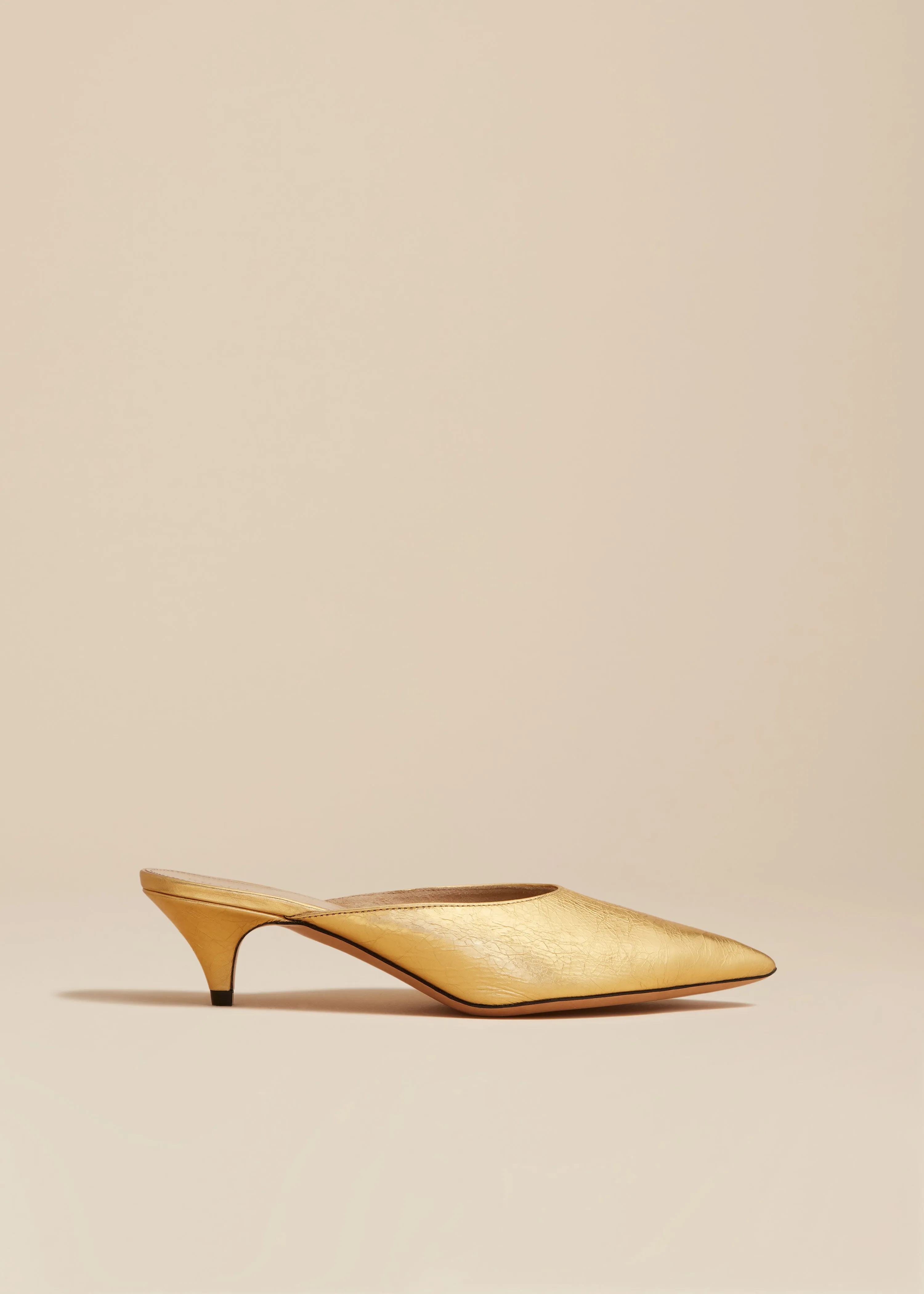 The River Mule in Gold Metallic Leather sold by KHAITE