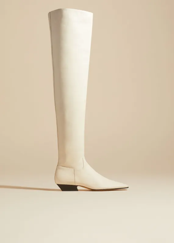 The Marfa Over-the-Knee Flat Boot in Off-White Leather sold by KHAITE