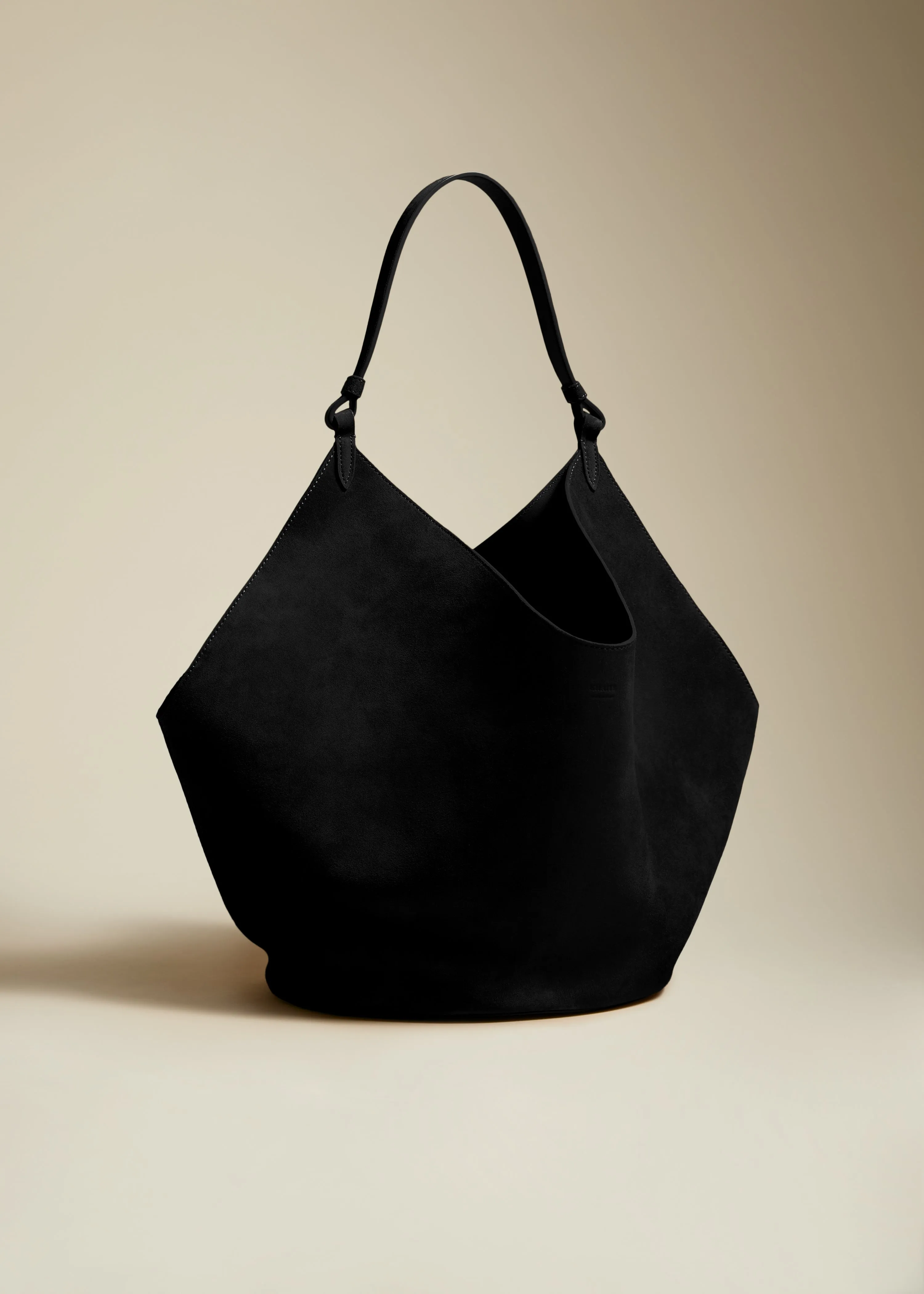 The Medium Lotus Tote in Black Suede sold by KHAITE