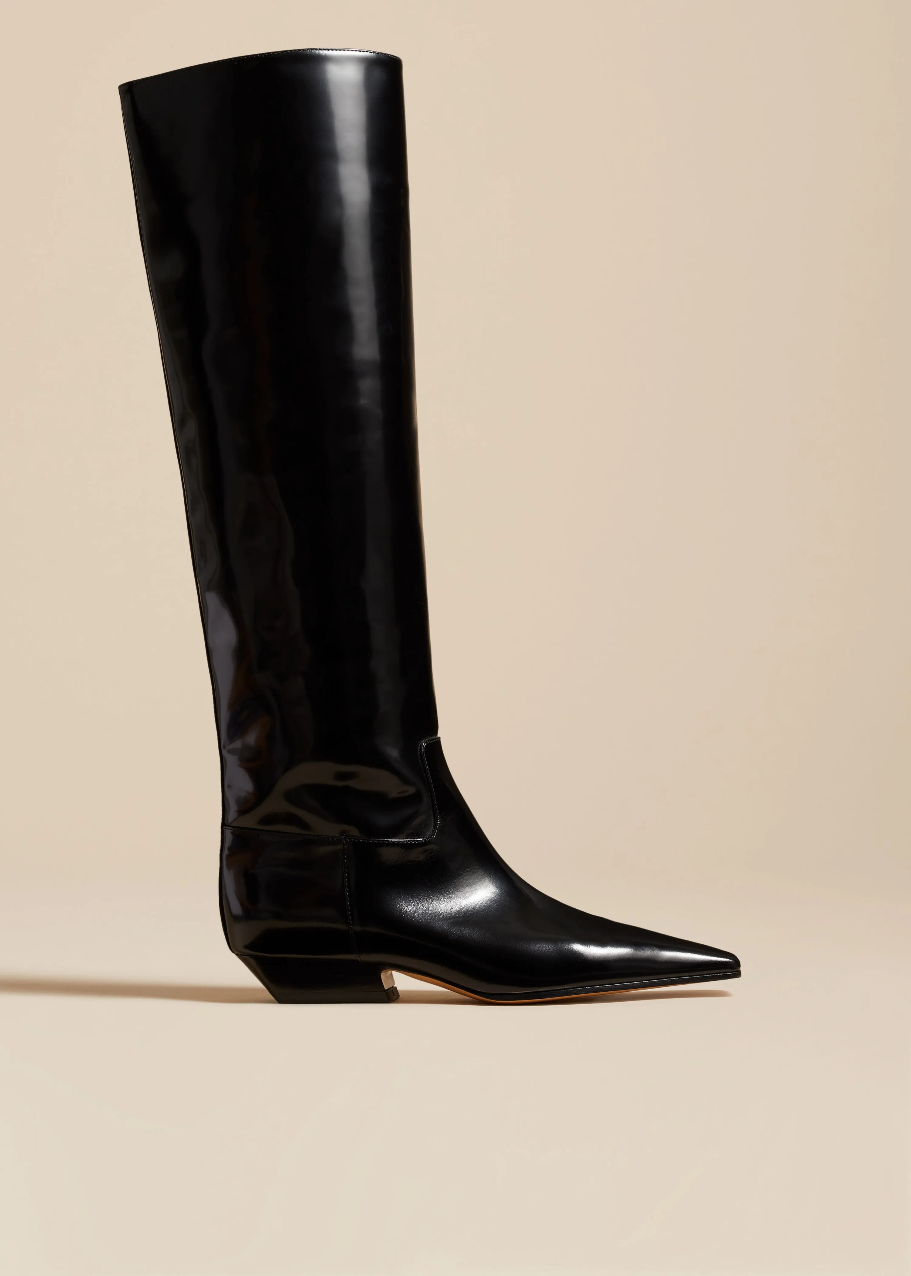 The Marfa Knee-High Boot in Black Brushed Leather sold by KHAITE