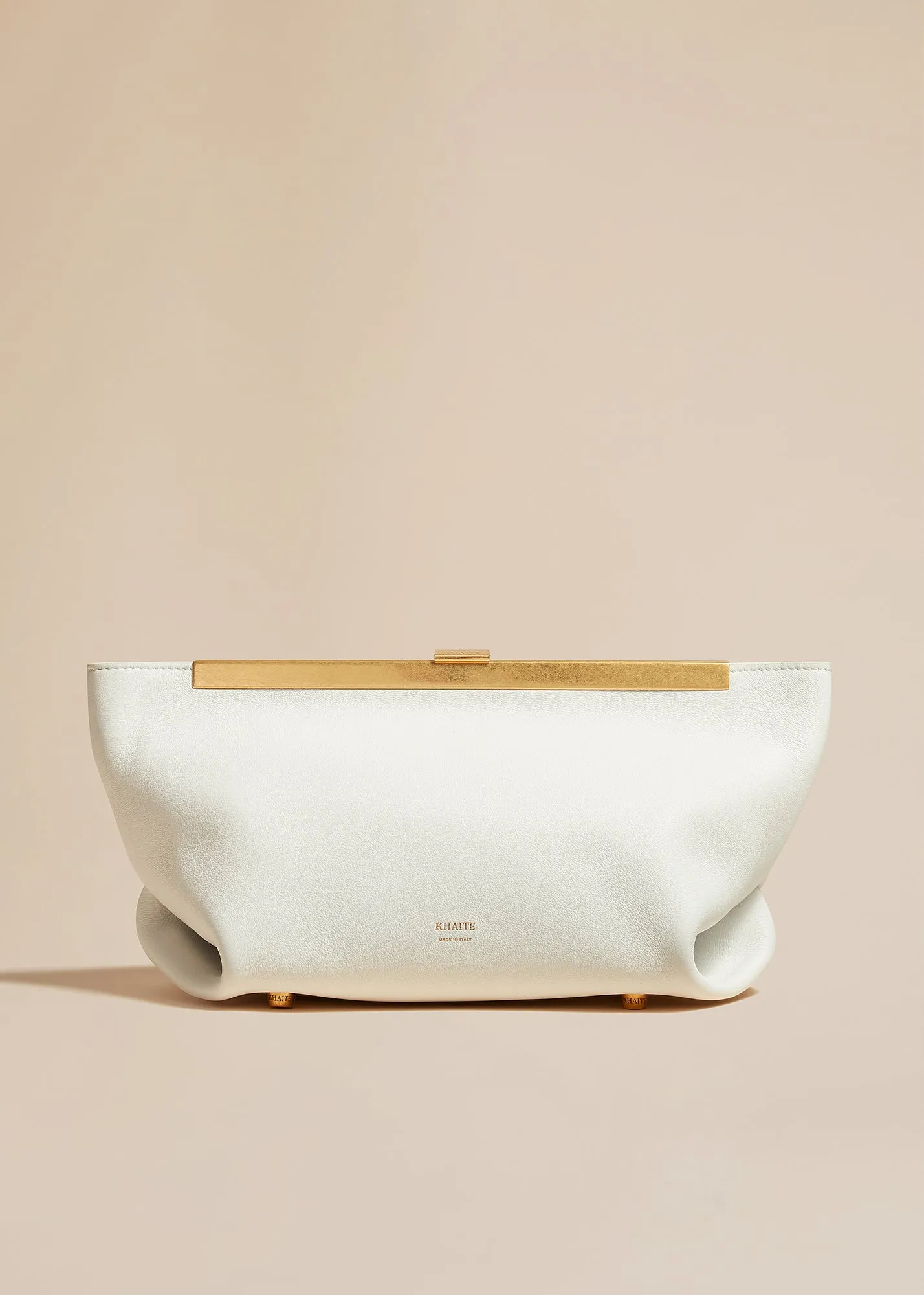 The Aimee Clutch in Optic White Leather sold by KHAITE