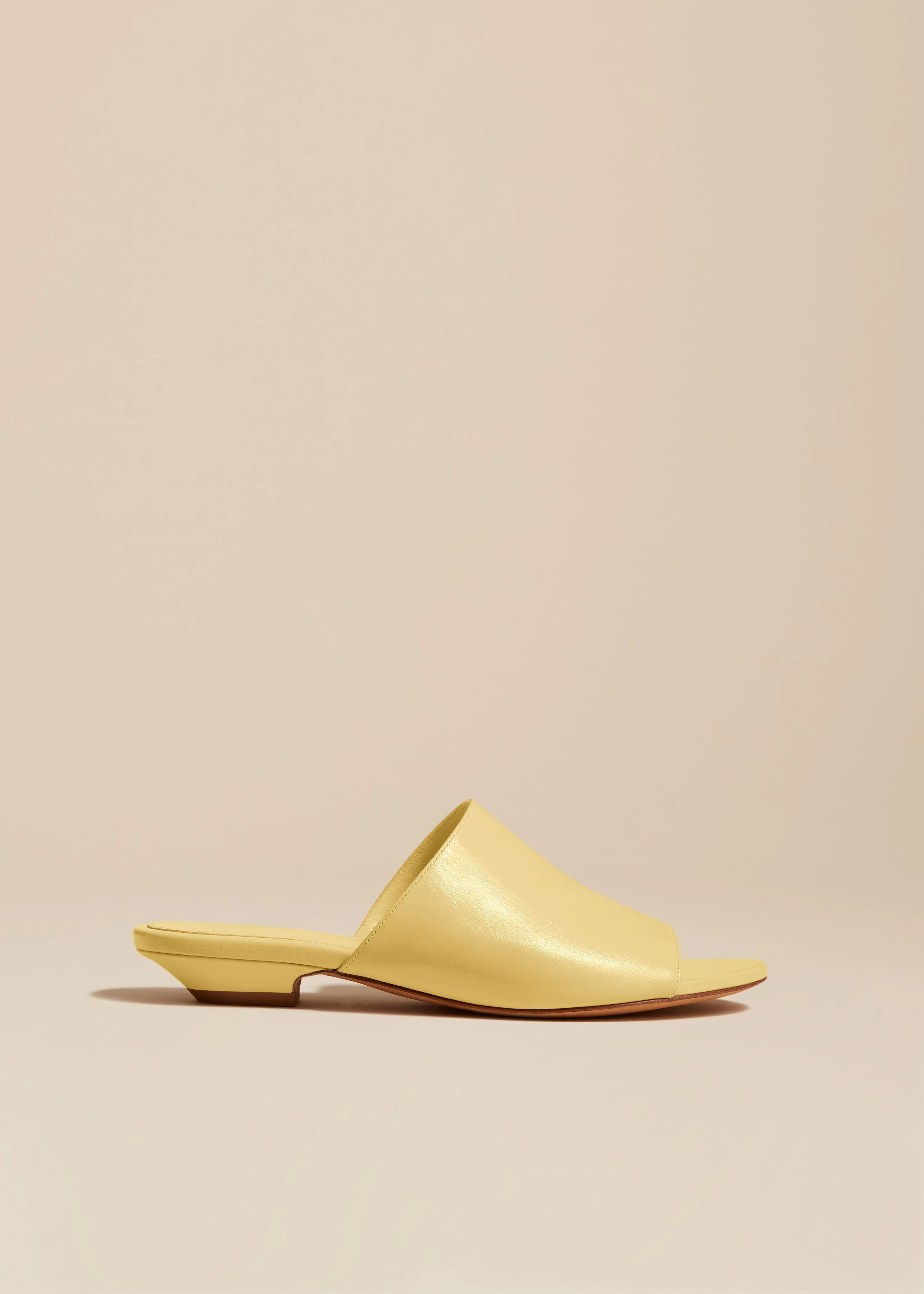The Marion Slide in Pale Yellow Leather sold by KHAITE