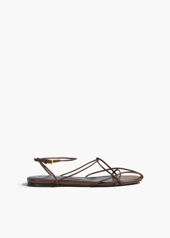 Loulou Flat Sandal in Cigar Leather sold by KHAITE