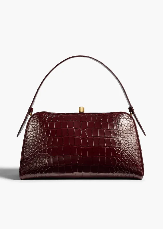 Cate Bag in Garnet Alligator sold by KHAITE