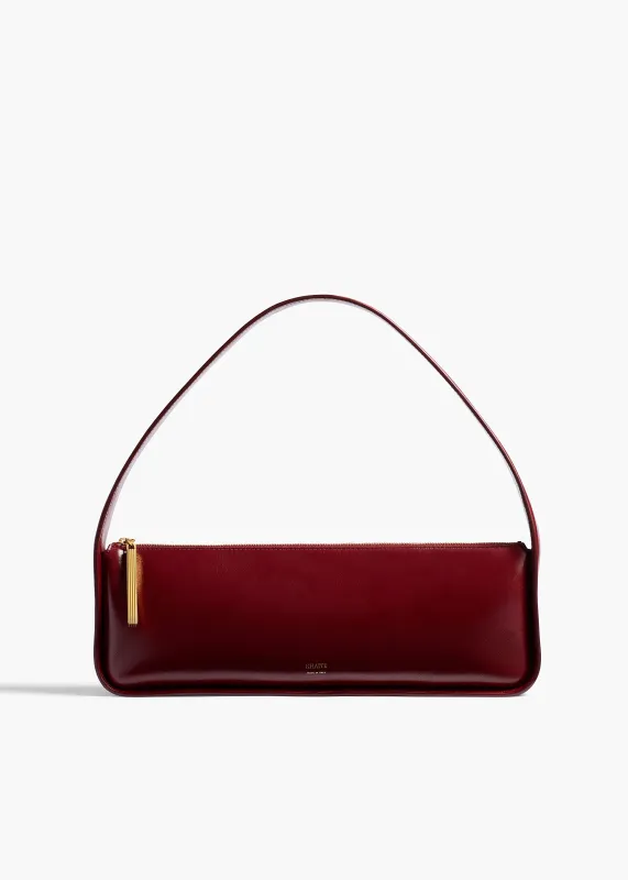 Lori Baguette Bag in Bordeaux Crackle Patent Leather sold by KHAITE