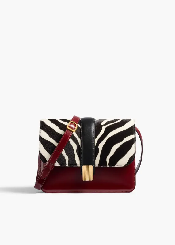 Blake Crossbody Bag in Zebra Print Haircalf and Oxblood Leather sold by KHAITE