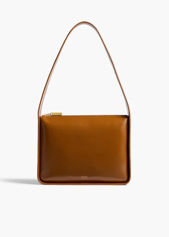 Lori Squared Bag in Dark Honey Crackle Patent Leather sold by KHAITE