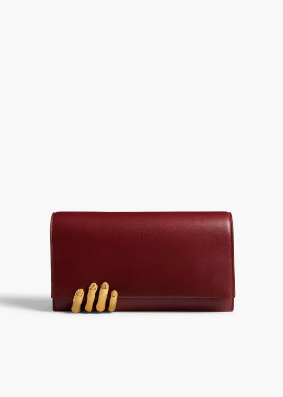 Sculpted Hand Clutch in Oxblood Leather sold by KHAITE