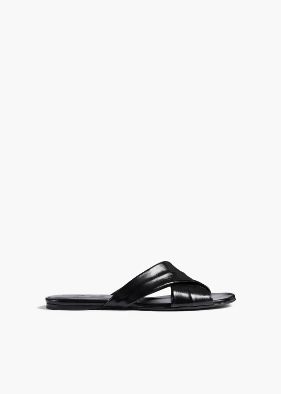 Liria Flat Sandal in Black Glazed Leather sold by KHAITE