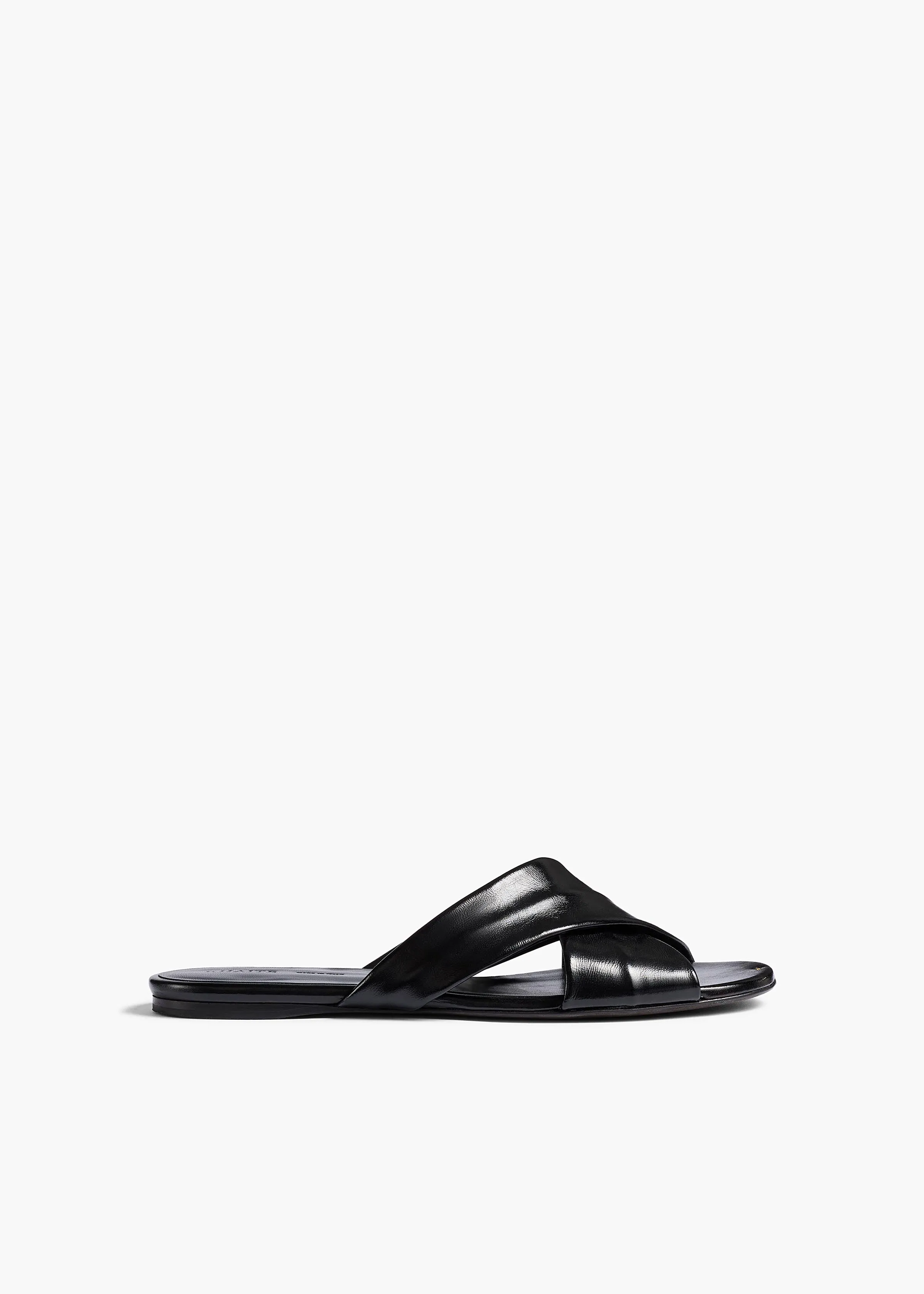 Liria Flat Sandal in Black Glazed Leather sold by KHAITE