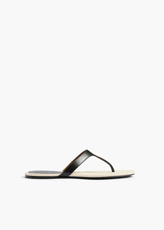 Archer Flat Sandal in Black Leather and Natural Canvas made by KHAITE
