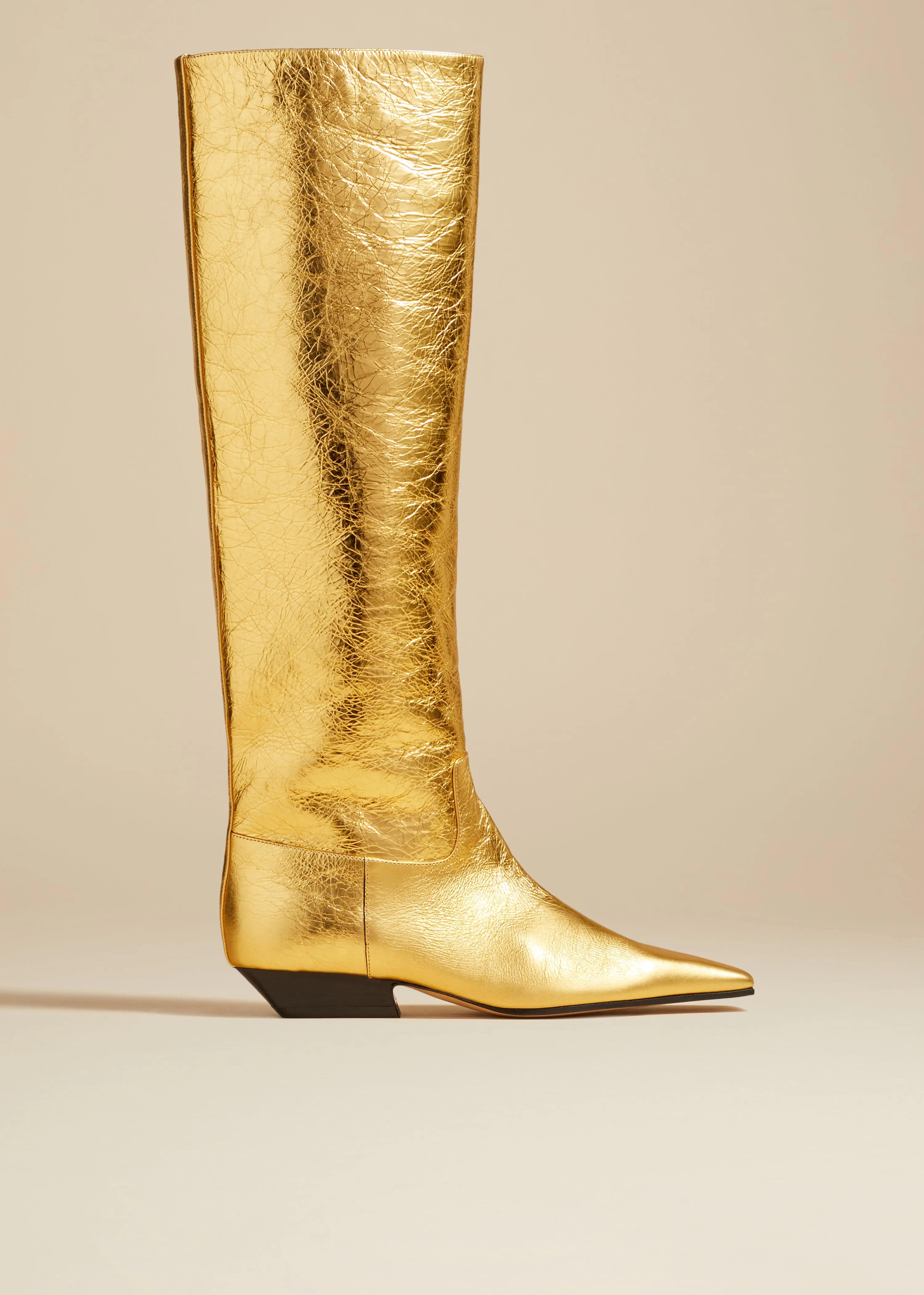 The Marfa Knee-High Boot in Gold Metallic Leather sold by KHAITE