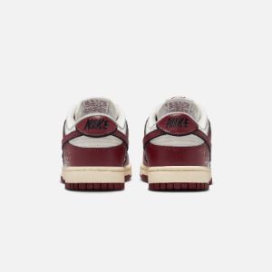 Nike WMNS Dunk Low SE - Sail / Team Red / Black / Muslin sold by Kith