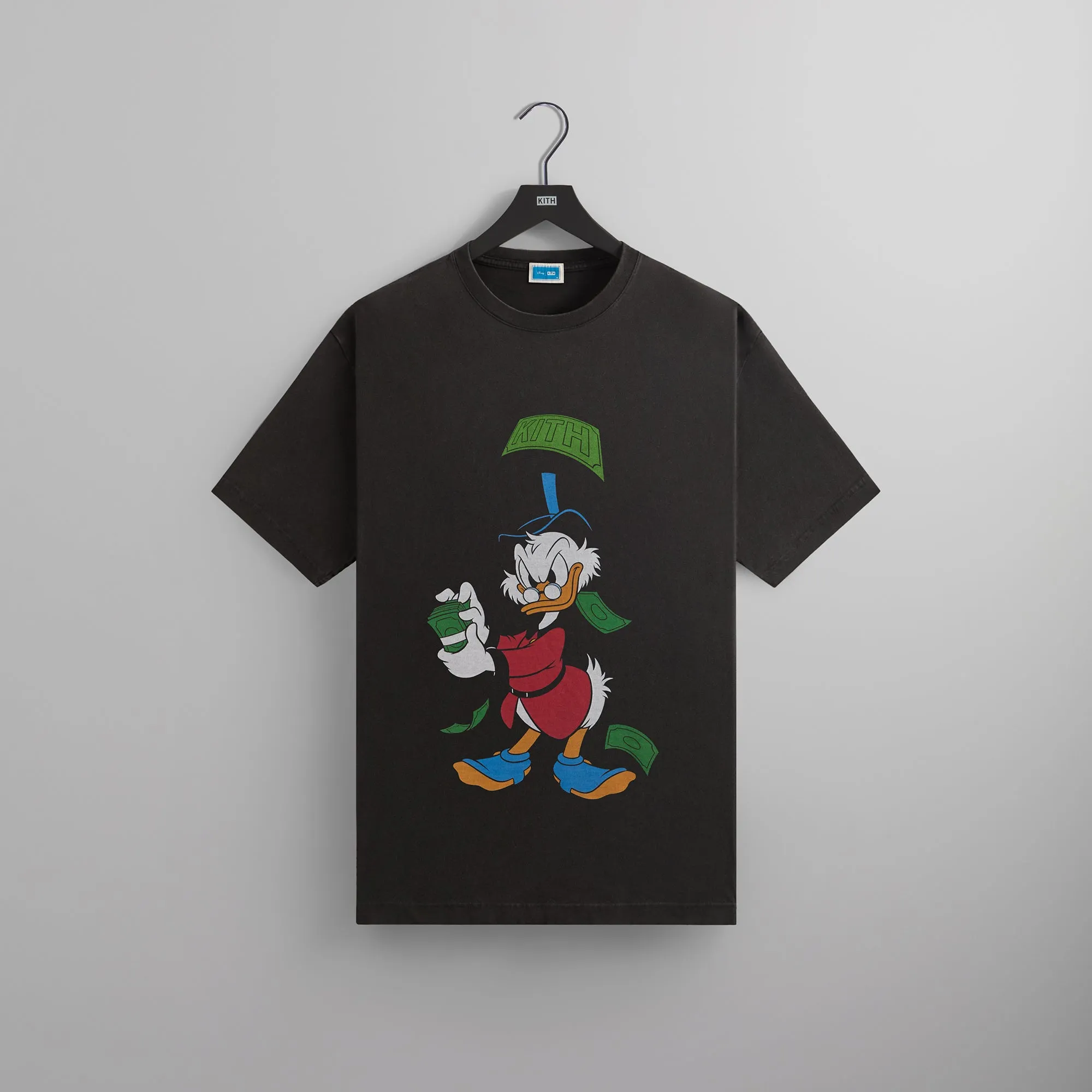 Disney | Kith for Donald Duck Scrooge Dollar Vintage Tee - Black sold by Kith