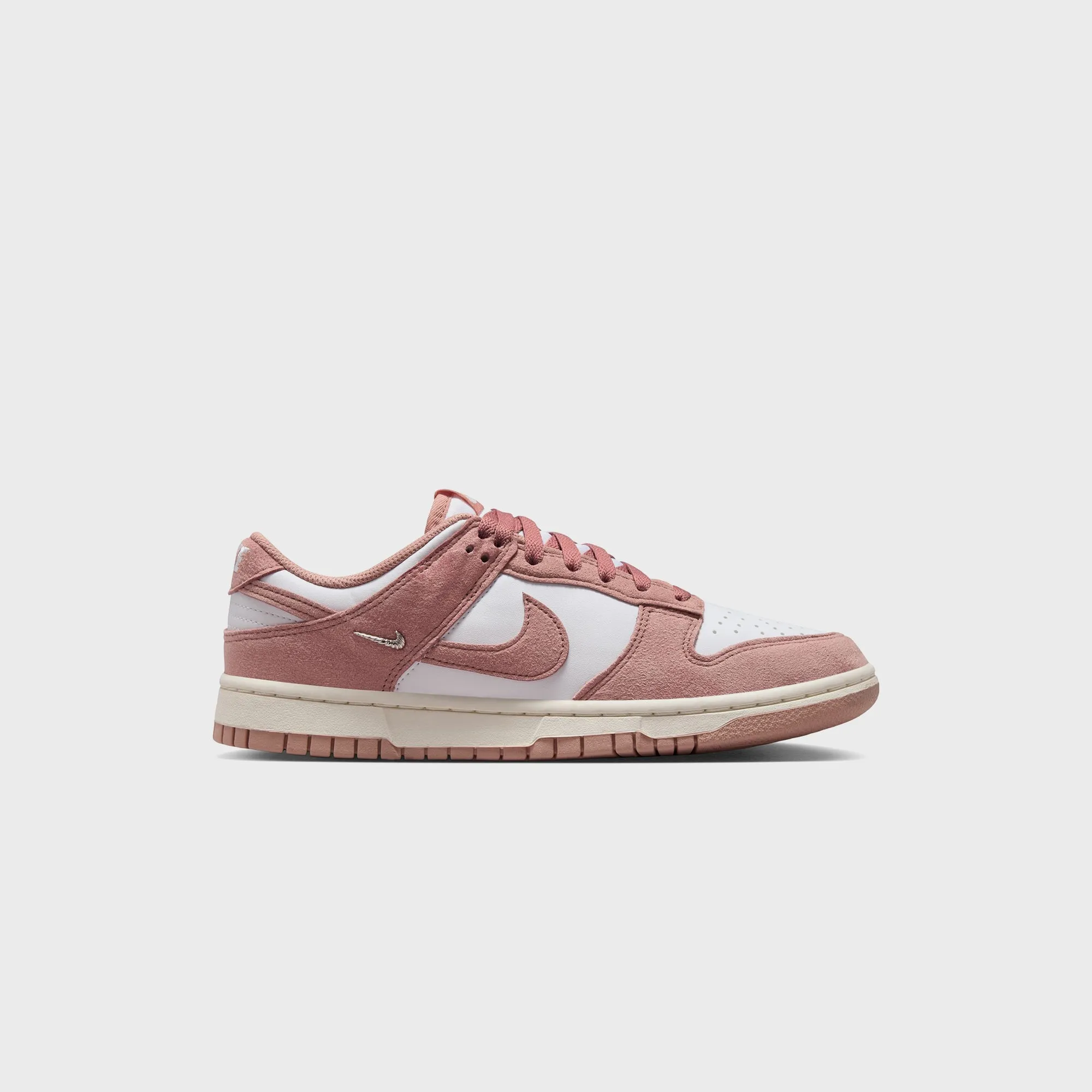 Nike WMNS Dunk Low - White / Particle Pink / Sail / Metallic Silver sold by Kith