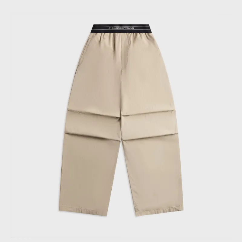 Alexander Wang Mid Rise Pleated Knee Pant with Elastic Logo - Stone sold by Kith