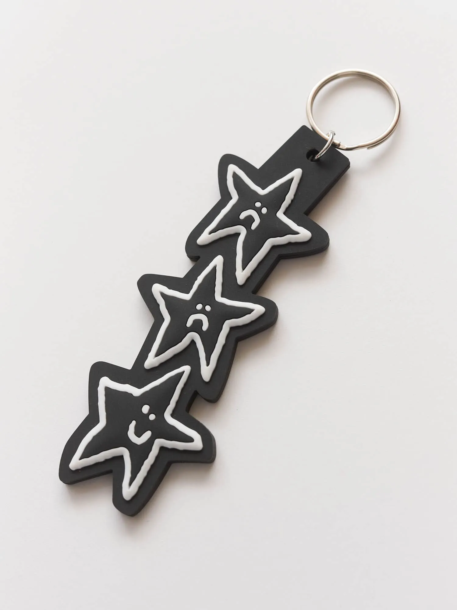 Happy Sad Star Keyring sold by Lazy Oaf